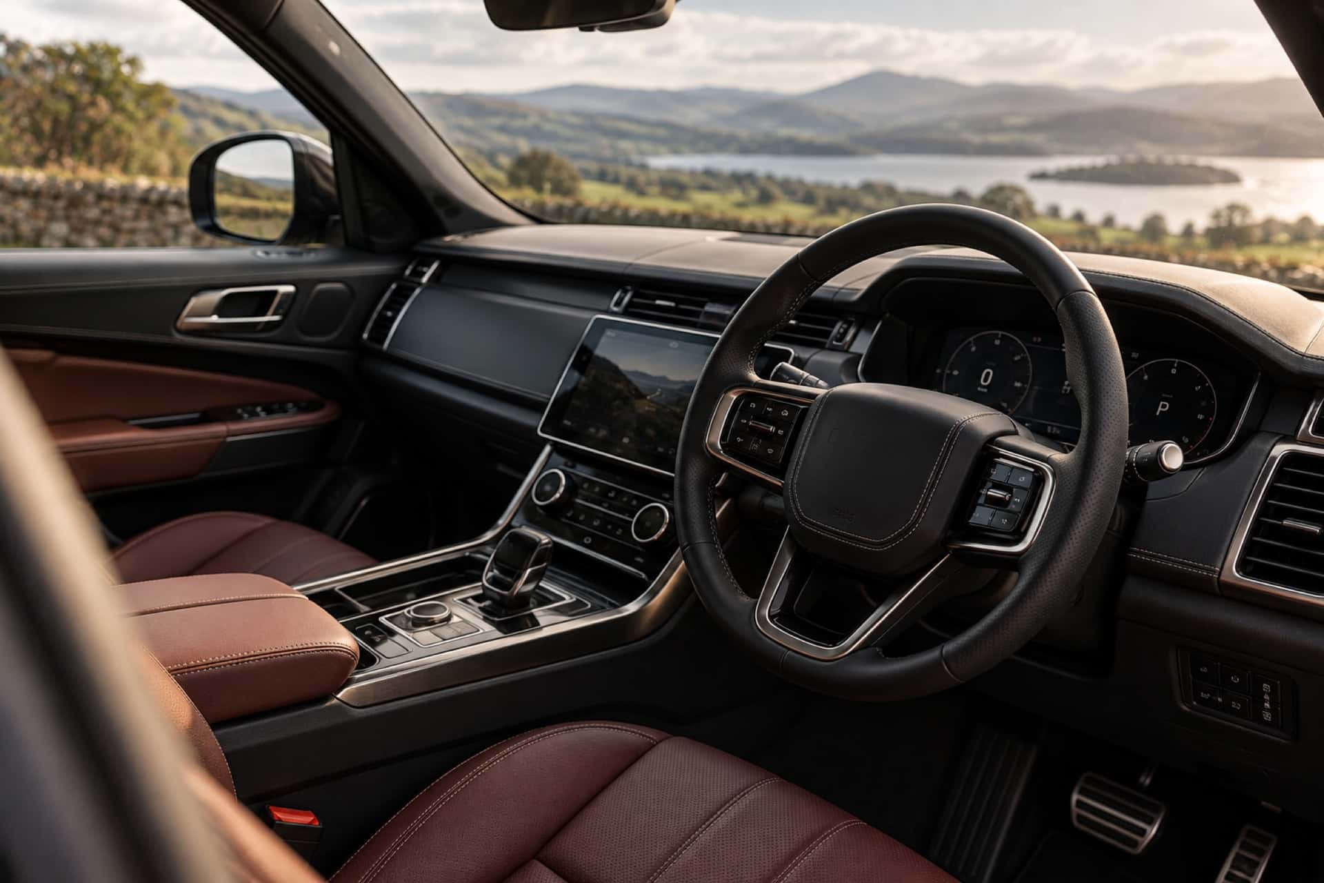 The interior of a right-hand drive car, looking across the steering wheel to open countryside